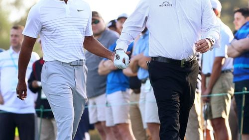 Tiger Woods and Phil Mickelson walk off the 10th tee box during a practice round for the Masters in April 2018.