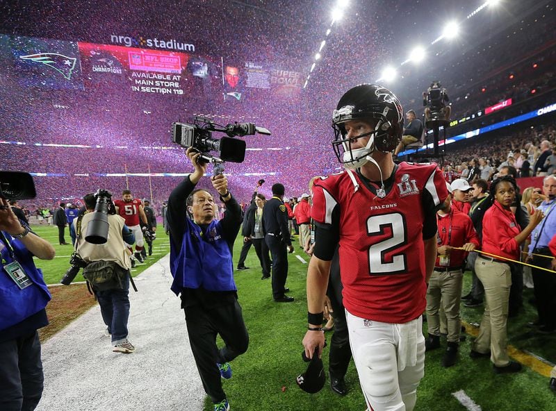A dejected Matt Ryan walks off the field as the confetti flys falling to the Patriots 34-28 in the Super Bowl on Sunday Feb. 5, 2017, in Houston.