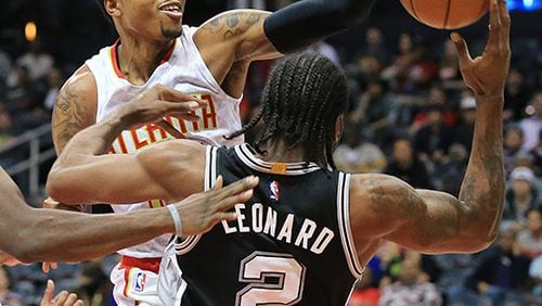 101415 ATLANTA: Hawks Kent Bazemore fouls Spurs Kawhi Leonard on his way to the basket during the first period in their preseason basketball game on Wednesday, Oct. 14, 2015, in Atlanta. Curtis Compton / ccompton@ajc.com