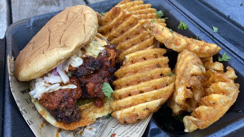 Menu items from Khana-Americana showcase creative playfulness, as common Indian flavors are woven into everyday American bites, such as with the tandoori fried chicken sandwich. Ligaya Figueras/ligaya.figueras@ajc.com