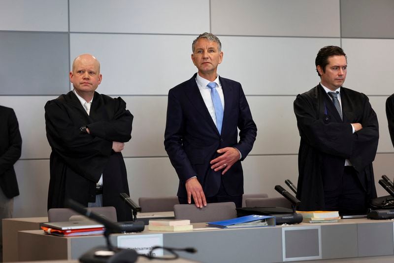 German far-right politician of the Alternative for Germany (AfD) Bjoern Hoecke, centre, attends his trial in the state court in Halle, Germany, Thursday, April 18, 2024. Bjoern Hoecke, goes on trial at the state court in Halle on charges related to his alleged use in a 2021 speech of a slogan used by the Nazis' SA stormtroopers. (Fabrizio Bensch/Pool via AP)