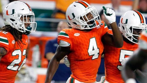 ILE - In this Nov. 11, 2017, file photo, Miami defensive back Jaquan Johnson (4) celebrates after intercepting Notre Dame quarterback Brandon Wimbush during the first half of an NCAA college football game, in Miami Gardens, Fla. Johnson was selected to the AP Preseason All-America team, Tuesday, Aug. 21, 2018.