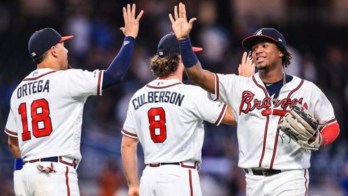 Ronald Acuna Jr. #13 high fives Rafael Ortega #18 of the Atlanta Braves following the game against the New York Mets at SunTrust Park on August 14, 2019 in Atlanta, Georgia. (Photo by Carmen Mandato/Getty Images)