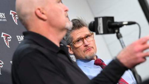 Atlanta Falcons general manager Thomas Dimitroff listens to coach Dan Quinn during a news conference held by the NFL football team, Monday, Dec. 30, 2019, in Flowery Branch, Ga.