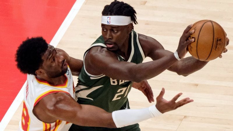 Hawks forward Solomon Hill (18) wraps up Milwaukee Bucks guard Jrue Holiday (21) during the first half Sunday, April 25, 2021, at State Farm Arena in Atlanta. (Ben Gray/AP)