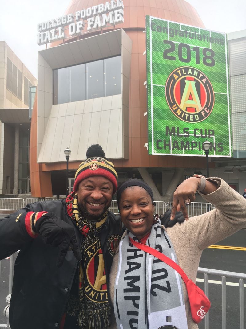 Derick Stripling and wife Melissa, both 40, don’t care if it’s dreary; they’re just happy the city has a big win. (Ben Brasch/AJC Staff)