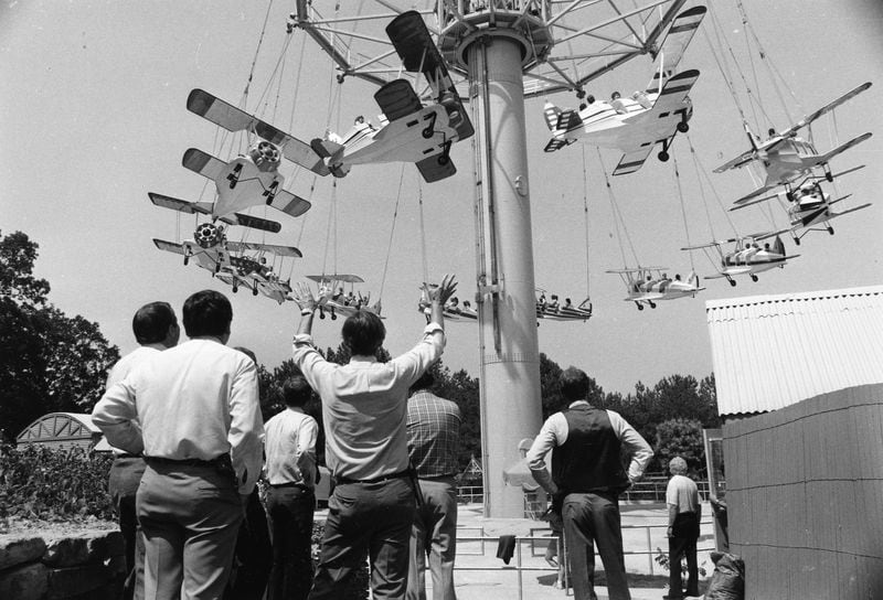 Officials of Six Flags Over Georgia watch as minor problems are corrected and a load of park patrons rise toward the top of the ride on June 20, 1984.