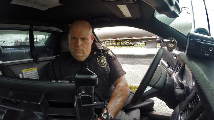 Cpl. John Lowe of the Doraville police department writes a speeding ticket for a driver he clocked at 51 mph in a 35 zone. On a per capita basis, Doraville generates the highest revenue from traffic tickets of any jurisdiction in metro Atlanta.