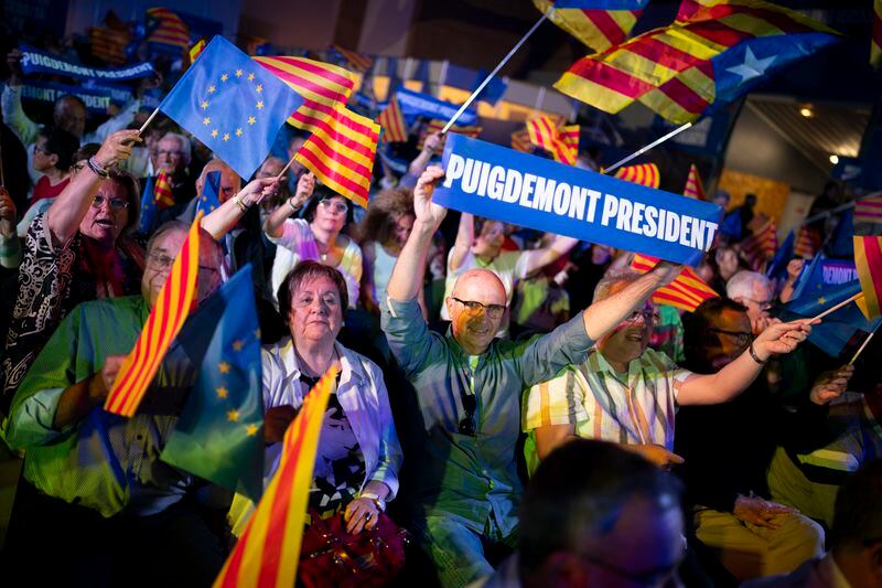 Supporters of Catalonia's former regional president Carles Puigdemont react during a campaign rally in Argelers, France, Wednesday, May 8, 2024. Carles Puidgemont, Catalonia's fugitive former leader, stares confidently out the backseat window of a car, the sun illuminating his gaze in a campaign poster for Sunday's critical elections in the northeastern Spanish region. Some nearly 6 million Catalans are called to cast ballots in regional elections on Sunday that will surely have reverberations in Spain's national politics. (AP Photo/Joan Mateu)