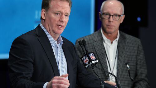 NFL Commissioner Roger Goodell, left, talks as Atlanta Falcons President and co-chairman of the NFL's competition committee Rich McKay, right, looks on during a press conference at the NFL owners meeting in Boca Raton, Fla., Wednesday, March 23, 2016. (AP Photo/Luis M. Alvarez)