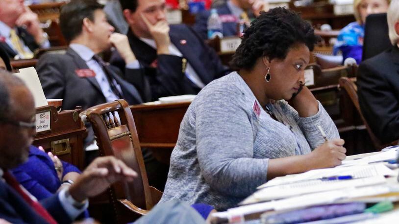 Mar. 16, 2016 - Atlanta - House Minority Leader Stacey Abrams, D - Atlanta, listens to debate on the bill. She later spoke in opposition to it. The House approved proposed changes to the controversial religious liberty bill. The new version cuts what opponents found most egregious about the earlier proposal, but still includes several passages they fear will allow legal discrimination. BOB ANDRES / BANDRES@AJC.COM