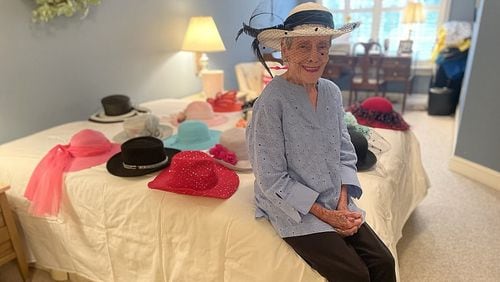 Betty Ewing, of Signal Mountain, has worn a hat to church every Sunday for 60 years. Here, she poses with part of her hat collection Wednesday. (Photo Courtesy of Mark Kennedy)