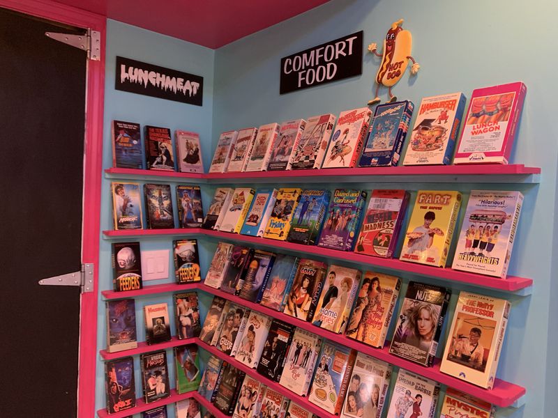 Since his basement had a kitchen, Woodstock's Anthony SantAnselmo created a "food themed" section in his fake video rental store. RODNEY HO/rho@ajc.com