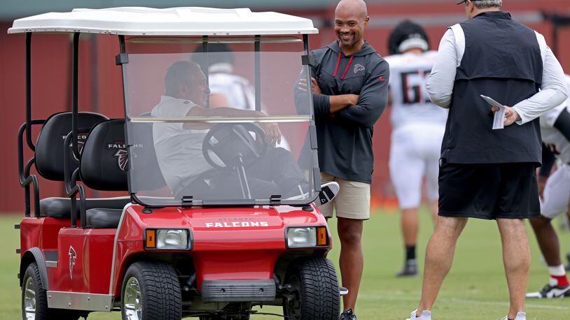 Falcons owner Arthur Blank, left, general manager Terry Fontenot, center, and coach Arthur Smith, right, talk during training camp at the Falcons Practice Facility, Monday, August 1, 2022, in Flowery Branch, Ga. (Jason Getz / Jason.Getz@ajc.com)