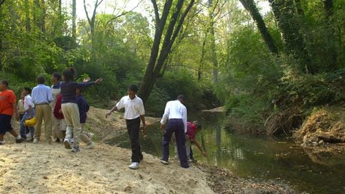001026 ATLANTA -Utoy Creek behind Beecher Hills Elemetary School - In recognition of Georgia Clean Water Month, the City of Atlanta installs stream protection signs after the ceremony- the school children enjoy the creek. (NICK ARROYO/AJC staff)