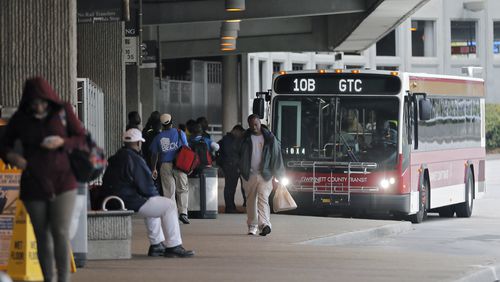 April 19, 2017 - Atlanta - MARTA passengers board a Gwinnett County Transit bus at the Doraville station. MARTAs Twitter account reported the parking lots were full at 8:11 AM. The collapse of a portion of I-85 some three weeks ago has been a headache for Atlanta drivers, but is proving to be a golden opportunity for MARTA. Long neglected in a car-crazy region, MARTA is getting a second look from commuters desperate to avoid gridlock. Ridership is up. MARTA parking lots are packed. BOB ANDRES /BANDRES@AJC.COM