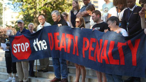 Death penalty opponents stand at the State Capitol on Tuesday, May 16, 2017, in Atlanta to protest the planned execution of J.W. Ledford for the 1992 murder of his elderly neighbor. Curtis Compton/ccompton@ajc.com
