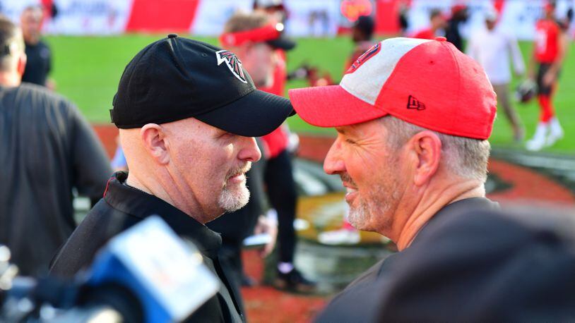 TAMPA, FLORIDA - DECEMBER 30: Head coach Dirk Koetter of the Tampa Bay Buccaneers congratulates head coach Dan Quinn of the Atlanta Falcons after a 34-32 falcons win at Raymond James Stadium on December 30, 2018 in Tampa, Florida. (Photo by Julio Aguilar/Getty Images)