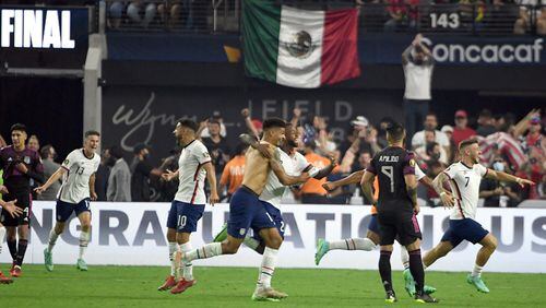 U.S. defender Miles Robinson, of Atlanta United, and midfielder Kellyn Acosta (23) reacts after their team defeated Mexico in the CONCACAF Gold Cup final soccer match Sunday, Aug. 1, 2021, in Las Vegas. (David Becker/AP)