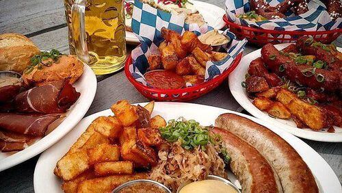 German beer garden snacks at Communion in Decatur, including Bavarian-style pretzels with hot mustard and grilled sausages with sauerkraut, mustard and beef fat-fried potatoes. CONTRIBUTED BY: Communion.