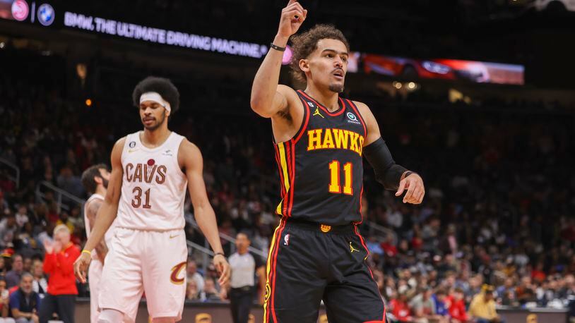 Atlanta Hawks guard Trae Young (11) reacts after making a basket against Cleveland Cavaliers center Jarrett Allen (31) during the first half at State Farm Arena, Friday, Feb. 24, 2023, in Atlanta. Jason Getz / Jason.Getz@ajc.com)