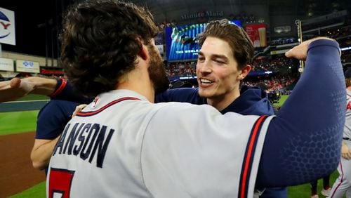 Braves starting pitcher Max Fried (facing) and shortstop Dansby Swanson celebrate after their win against the Astros to win Game 6 of the World Series. Fried will start opening day against the Reds. (Curtis Compton / curtis.compton@ajc.com)