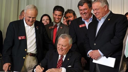 April 21, 2014. Ellijay, GA: Surrounded by bill supporters, Governor Nathan Deal signs House Bill 60 into law during a signing event in Ellijay, GA. The gun law is a broad loosening of Georgia's gun restrictions. BRANT SANDERLIN /BSANDERLIN@AJC.COM .
