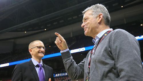 Hawks owner Tony Ressler (right) and general manager Wes Wilcox (left) confer as the team prepares to play their first regular season basketball game in 2015, in Atlanta. Curtis Compton / ccompton@ajc.com