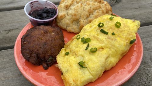 The pimento cheese omelet, which comes with a biscuit and choice of side, is a popular menu item at Buttermilk Kitchen in Buckhead. Ligaya Figueras/ligaya.figueras@ajc.com