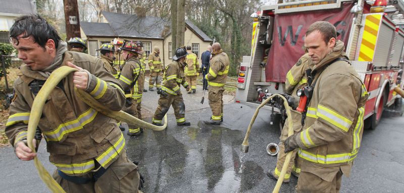 Feb. 14, 2012 Atlanta : Atlanta firefighters Frank Martinez and Chris Moss (right) of Squad 4 roll up hose after battling a blaze Tuesday. Atlanta firefighters made a quick knock down on a house fire at 1750 Madrona Street in Atlanta Tuesday, Feb. 14, 2012. Two occupants of the house were already evacuated when crews arrived on the call that came in at 10:09 AM according to battalion chief, Raymond Bearden. The bulk of the fire was in the basement where after crews checked for extensions throughout the house and made complete searches. There were no exposure problems to the adjacent neighboring homes. No one was hurt and the fire is under investigation..  John Spink, jspink@ajc.com