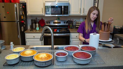 Heaven Waits of Heavenly Bakes works in the kitchen of her Buford apartment.  PHIL SKINNER FOR THE ATLANTA JOURNAL-CONSTITUTION.