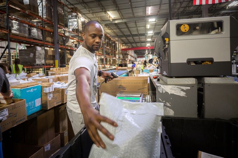 The Port of Savannah has led to a surge in warehouse and fulfillment center development in the Savannah area. Here, Anthony Riley, Jr. packs items into a bin for shipping at a massive Fulfillment.com facility. Riley is operations manager for the company, which ships packages for all sorts of retailers. (AJC Photo/Stephen B. Morton)