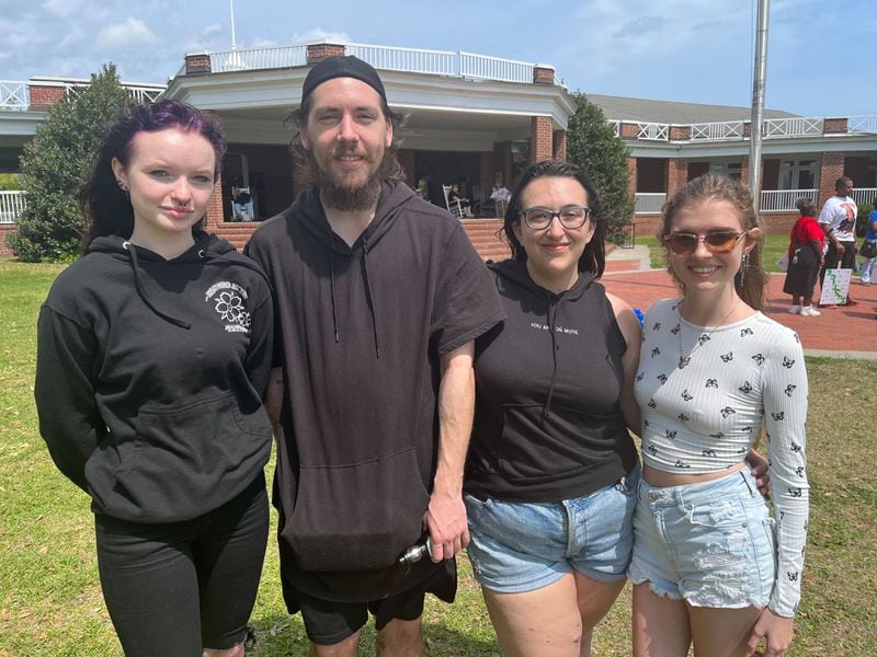 Emily Dobson (left to right), Ryan Davis, Jillian Schneider and Mallery Culpepper gather together near the end of the rally at St. Simons Island on Saturday afternoon.