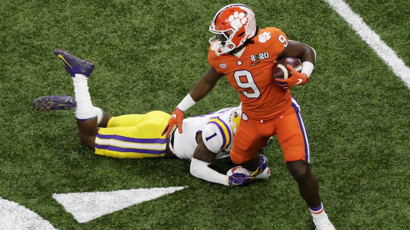 Clemson running back Travis Etienne is tackled by LSU cornerback Kristian Fulton during the first half. (AP Photo/Eric Gay)