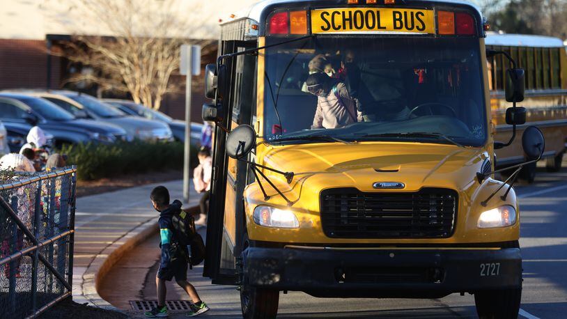 Students arrive at Norcross Elementary School on Jan. 10, 2022. Gwinnett County Public Schools latest reports of COVID-19 cases show that last week the district reached its highest weekly total for the 2021-2022 school year. (Miguel Martinez for The Atlanta Journal-Constitution)