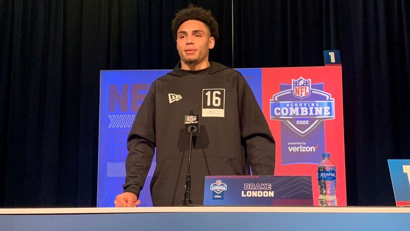 Drake London speaks at the NFL scouting combine.