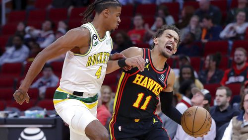 Atlanta Hawks guard Trae Young (11) reacts as he drives around Houston Rockets guard Jalen Green (4) during the first half of an NBA basketball game Friday, Nov. 25, 2022, in Houston. (AP Photo/Michael Wyke)