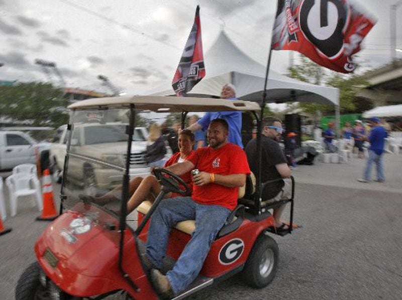 Oct. 26, 2012 - Jacksonville, FL - James and Kathy Griffin, from Waycross, cruised through the RV lot. Fans were in a festive move in the RV park behind EverBank Field in Jacksonville on the eve of the Georgia Florida football game. BOB ANDRES BANDRES@AJC.COM