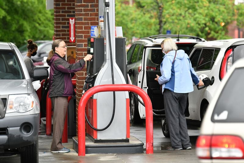 Customers wait their turn to fill up at Kroger Fuel Center in Decatur on Wednesday, May 12, 2021. Throughout metro Atlanta, since Tuesday, many drivers are reporting empty pumps or higher prices with long lines, limited grades and spending caps. (Hyosub Shin / Hyosub.Shin@ajc.com)