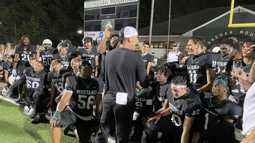 Kennesaw Mountain head coach Caleb Carmean talks to his team after its 21-17 victory over Pope in a Region 6-6A game on Oct. 15, 2021 (Photo by Chip Saye)
