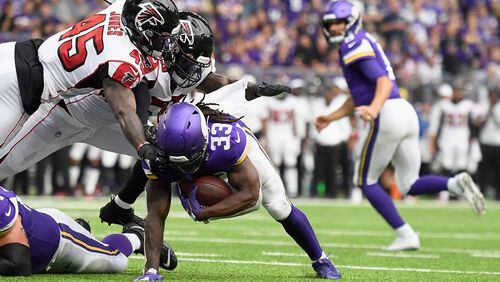MINNEAPOLIS, MINNESOTA - SEPTEMBER 08: Richie Brown #49 and De'Vondre Campbell #59 of the Atlanta Falcons tackle Dalvin Cook #33 of the Minnesota Vikings just short of the goal line during the second quarter of the game at U.S. Bank Stadium on September 8, 2019 in Minneapolis, Minnesota. (Photo by Hannah Foslien/Getty Images)