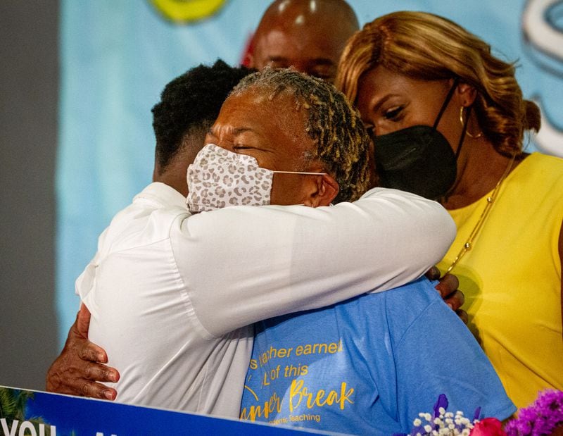  Teacher Sonja Lewis receives a hug from Mays High School Quindarian Boykin after learning she won a free trip including airfare and hotel accommodations to any Delta Vacations destination within the U.S., Mexico, or the Caribbean Friday, May 7, 2021.  STEVE SCHAEFER FOR THE ATLANTA JOURNAL-CONSTITUTION