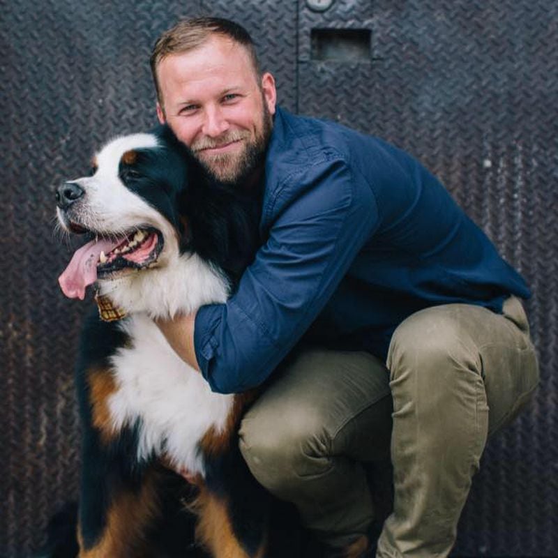 Gusto! owner Nate Hybl and his Bernese Mountain Dog, Buckley, can often be found on the restaurant's Peachtree Road patio.