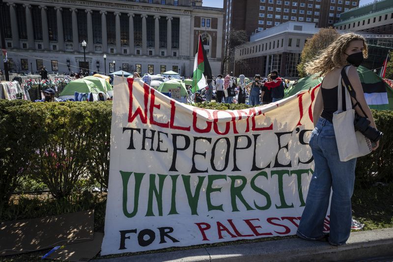 A sign is displayed in front of the tents erected at the Pro-Palestine protest encampment at the Columbia University campus in New York on Monday April 22, 2024. (AP Photo/Stefan Jeremiah)