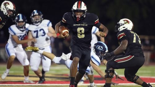 GAC quarterback Deymon Fleming (8) runs for yardage in the first half of a recent game against Lovett in Norcross. (Jason Getz/Special to the AJC)