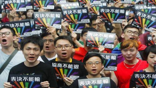 Supporters of same-sex marriages in Taiwan gather in Taipei on Friday with signs that read  'Vote Can't Be Defeated..''