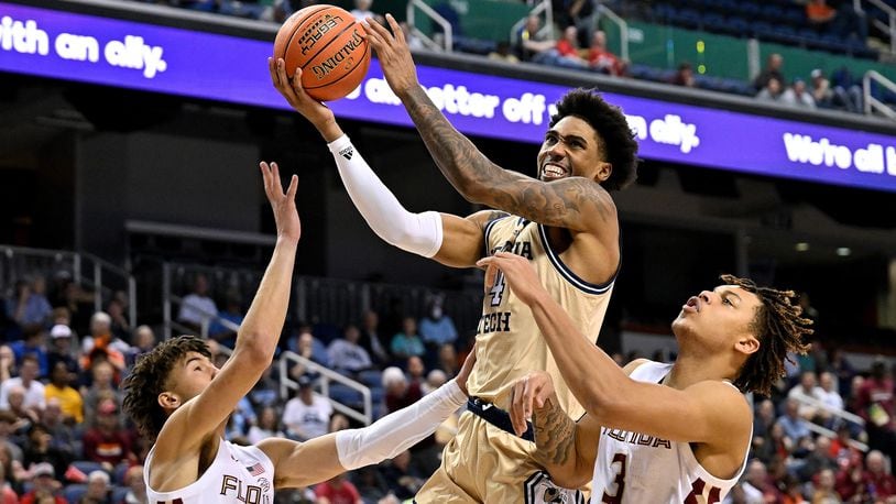 Georgia Tech's Ja'von Franklin drives between Florida State's Jalen Warley (1) and Cam Corhen during the second half in the first round of the ACC Tournament on Tuesday in Greensboro, North Carolina. (Grant Halverson/TNS)