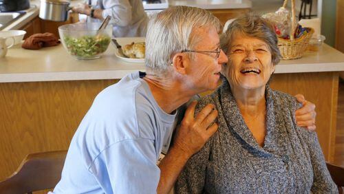 Bill Kelly, 64, gives Jackie Kindl, 81, a hug at lunch in Lombard, Illinois, on Thursday, September 26, 2013. Self-sufficient seniors share a house in a residential neighborhood in Lombard, one of four share houses run by the non-profit Senior Housing Share.