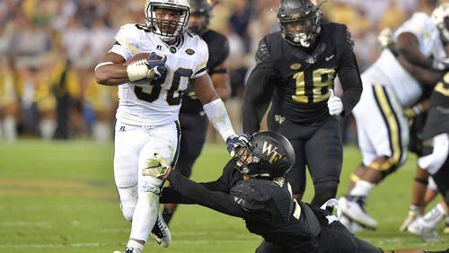 October 21, 2017 Atlanta - Georgia Tech running back KirVonte Benson (30) eludes a tackle by Wake Forest defensive back Jessie Bates III (3) in the first half of an NCAA college football game at Bobby Dodd Stadium on Saturday, October 21, 2017. HYOSUB SHIN / HSHIN@AJC.COM