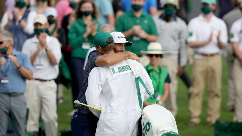 Nov. 15, 2020 - Augusta, Ga. - Dustin Johnson celebrates with his brother and caddie Austin Johnson on the 18th green winning the 2020 Masters Tournament Sunday, Nov. 15, 2020, at Augusta National. (Curtis Compton / Curtis.Compton@ajc.com)